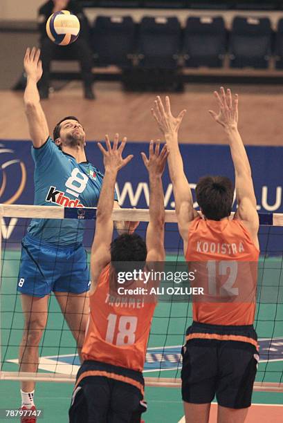 Alberto Cisolla of Italy tries to break the block of Koolstr Wytze and Jeroen Paul Trommel of The Netherlands during the opening match in the...