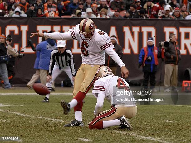 Quarterback Wide receiver Running back Placekicker Joe Nedney of the San Francisco 49ers kicks an extra point out of the hold of Andy Lee during a...