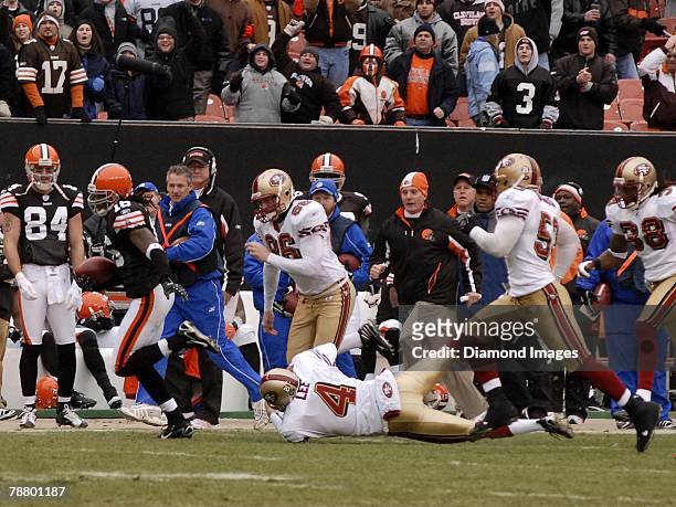 Wide receiver Josh Cribbs of the Cleveland Browns avoids Andy Lee, Brian Jennings, Jeff Ulrich and Dashon Goldson of the San Francisco 49ers while...