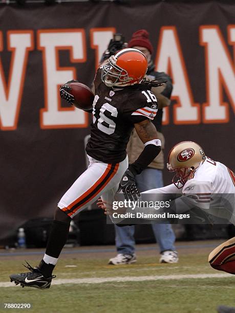Wide receiver Josh Cribbs of the Cleveland Browns runs through the tackle of punter Andy Lee of the San Francisco 49ers on a 76-yard punt return for...