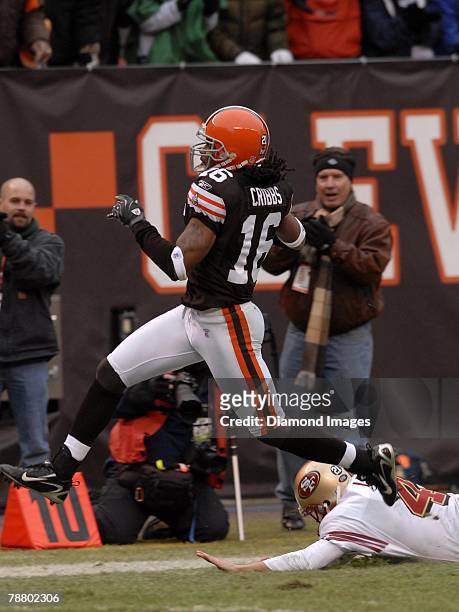 Wide receiver Josh Cribbs of the Cleveland Browns runs through the tackle of punter Andy Lee of the San Francisco 49ers on a 76-yard punt return for...