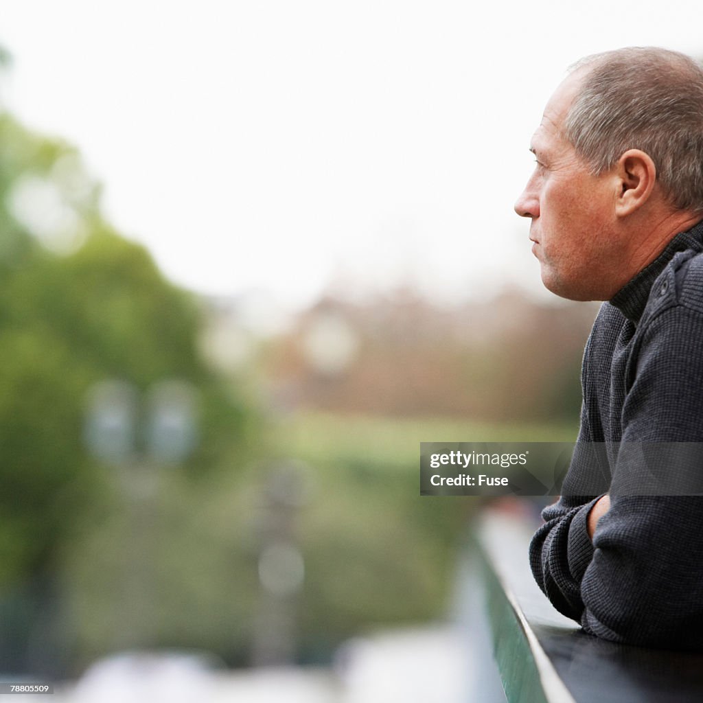 Middle-Aged Man Leaning on Railing