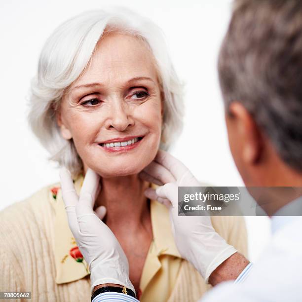 physician checking patients glands - thyroid exam stock pictures, royalty-free photos & images