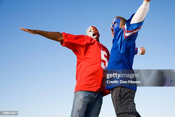 cheering football fans - football body paint stock pictures, royalty-free photos & images