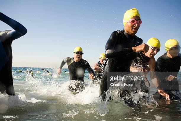 swimmers in triathlon - swimming competition stock pictures, royalty-free photos & images