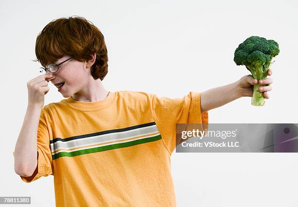 boy with broccoli holding nose - 鼻をつまむ ストックフォトと画像