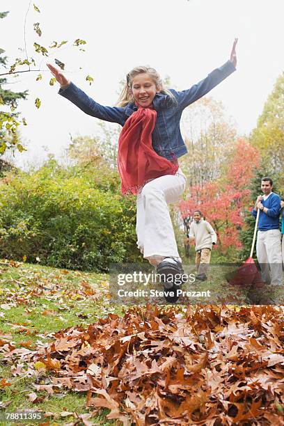 child playing in leaves - steve prezant stock pictures, royalty-free photos & images
