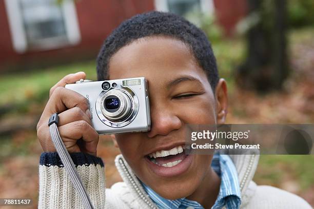 boy using digital camera outdoors - steve prezant stock pictures, royalty-free photos & images