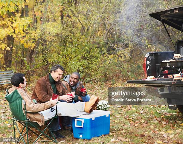 friends at tailgate party in woods - steve prezant stock pictures, royalty-free photos & images
