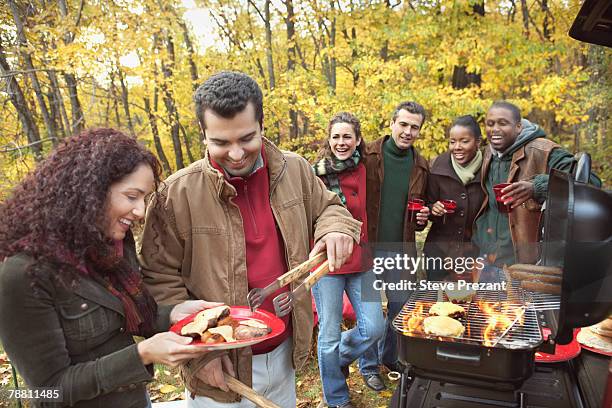 friends at tailgate party in woods - steve prezant stock pictures, royalty-free photos & images