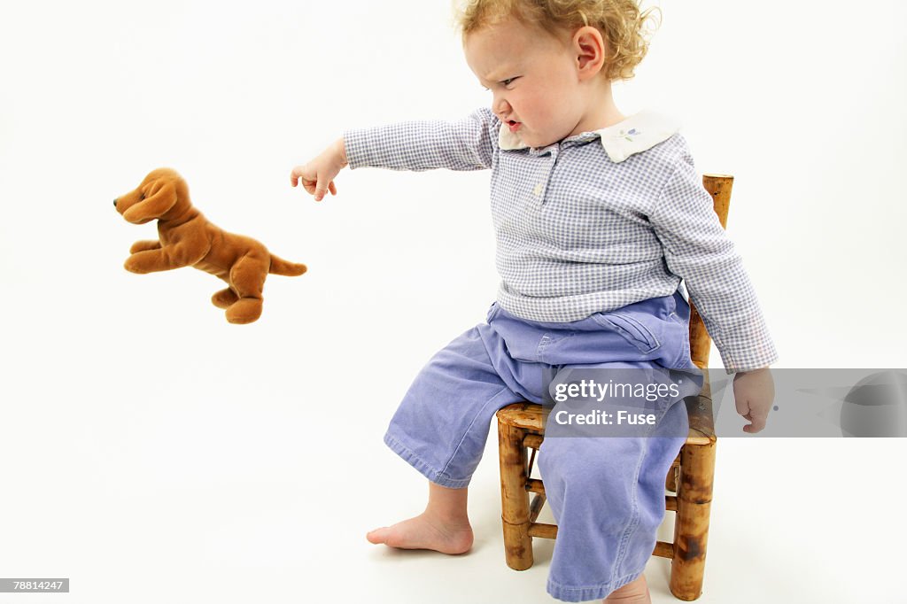 Baby Girl Throwing Stuffed Animal
