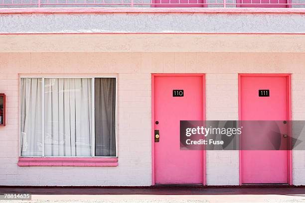 pink motel room doors - モーテル ストックフォトと画像