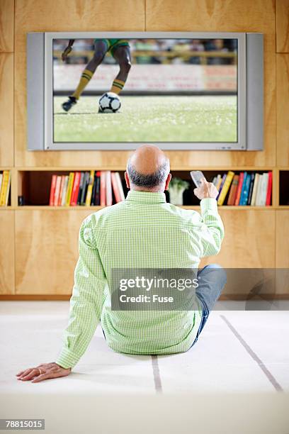 man watching tv - concurso tv fotografías e imágenes de stock