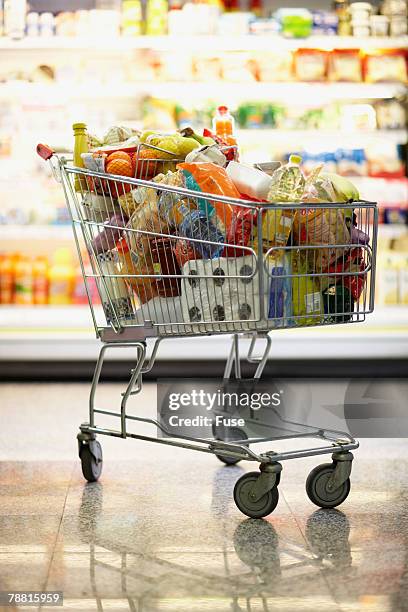 full shopping cart in grocery store - full stock pictures, royalty-free photos & images