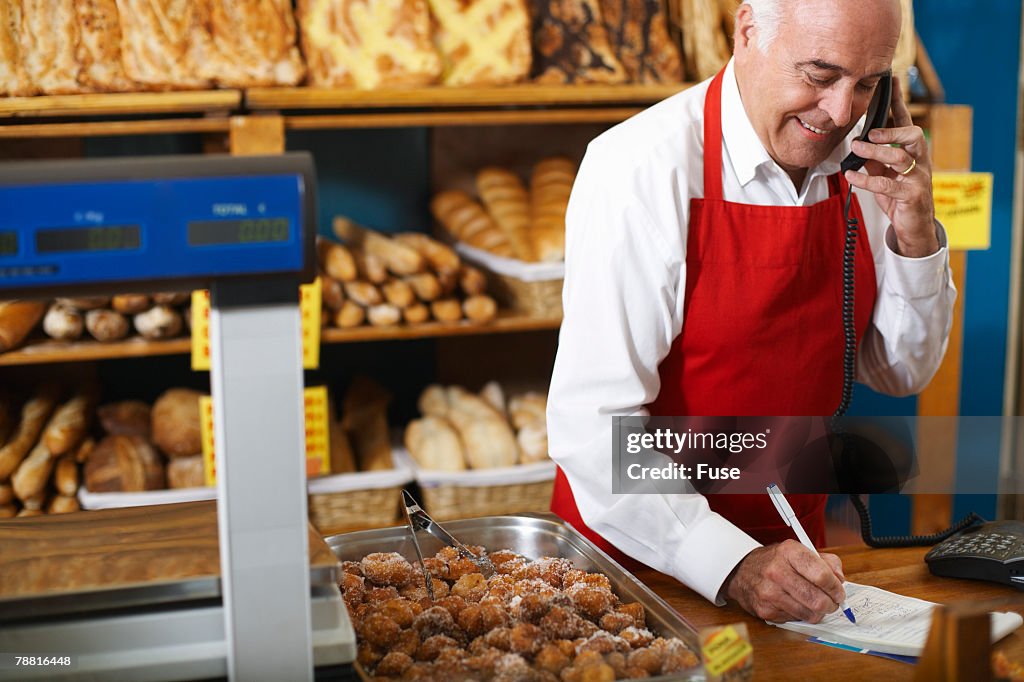 Deli Owner Taking Order By Telephone