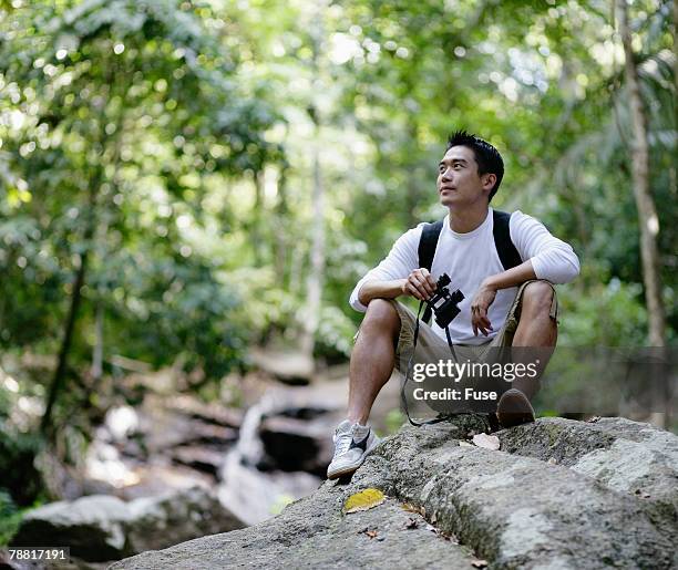 hiker with binoculars - binoculars woods stock-fotos und bilder