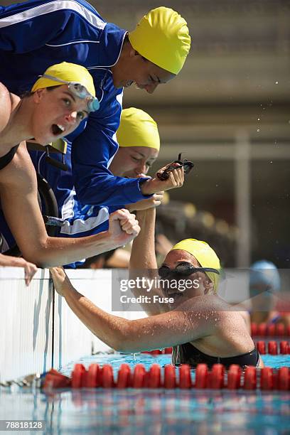 swimming team celebrating victory - swim meet stock pictures, royalty-free photos & images