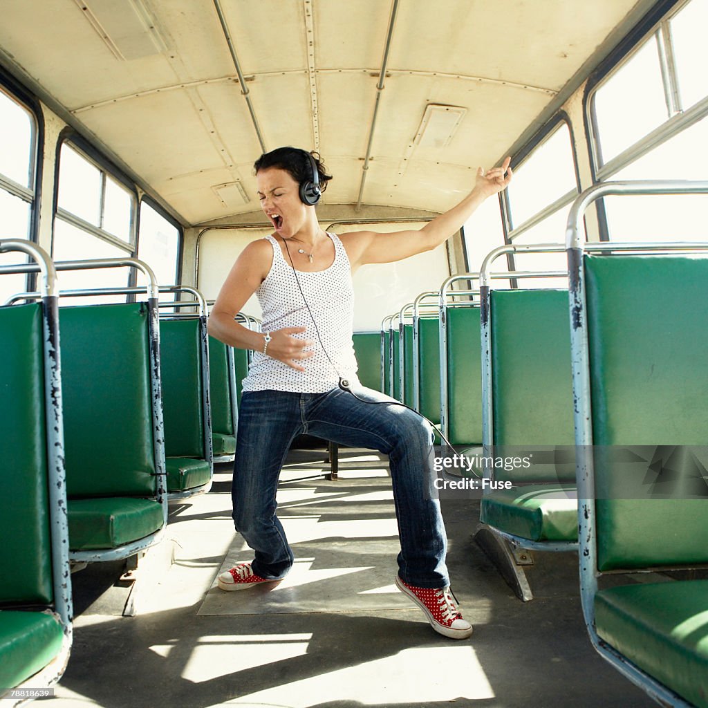 Woman in a Bus Listening to Music