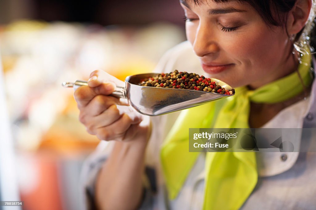 Woman Smelling Peppercorn