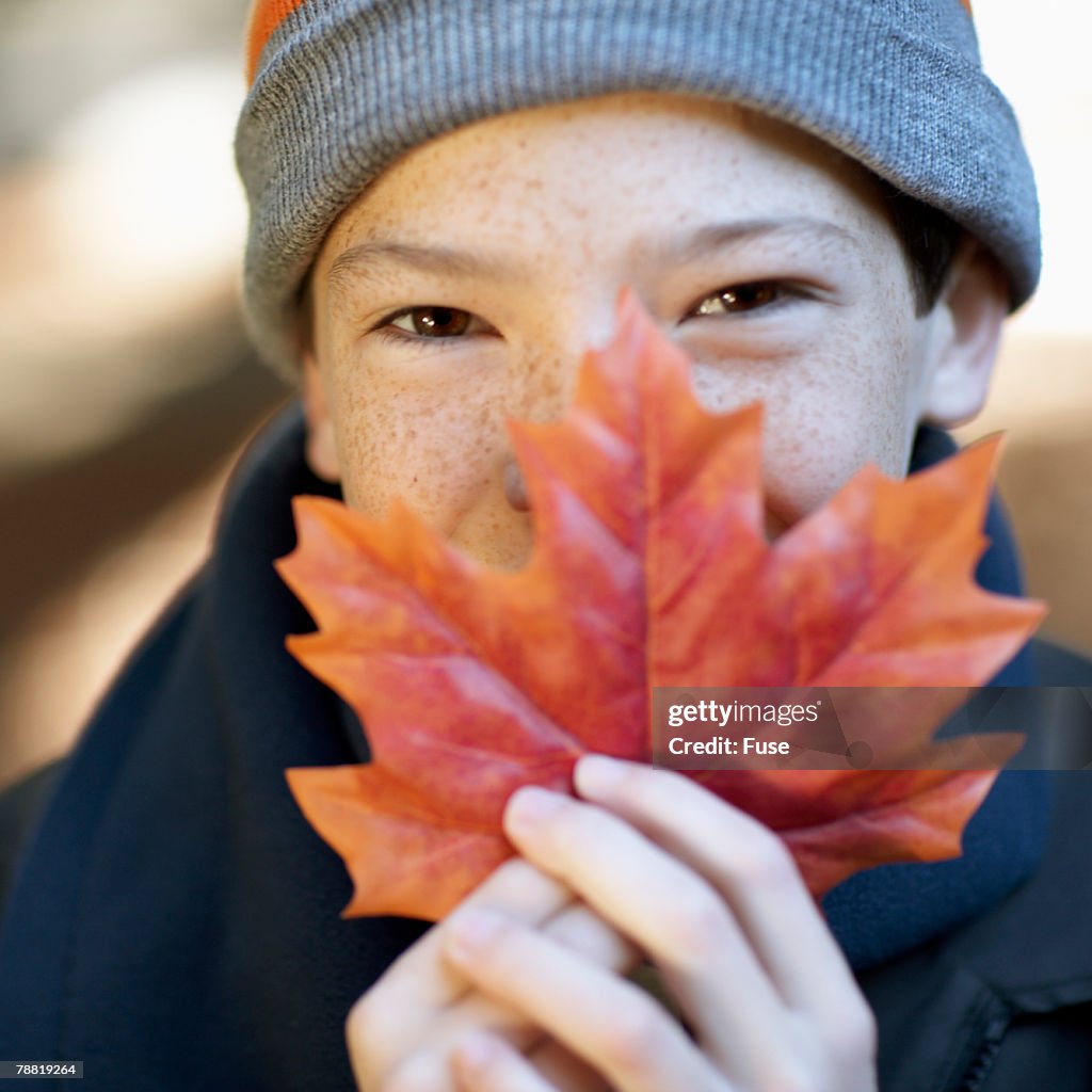 Boy Holding Autumn Leaf