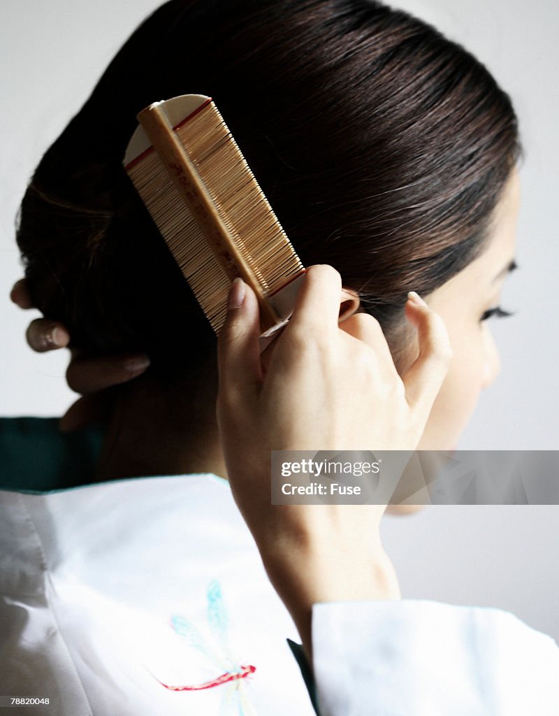 Young Woman Combing Her Hair