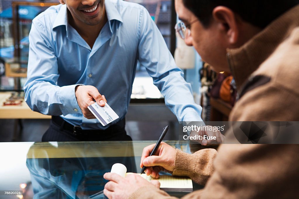 Customer Giving Clerk Credit Card