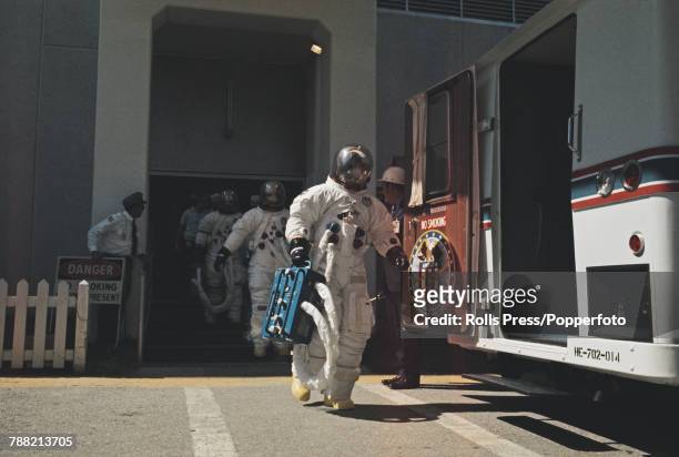 Wearing space suits, the Apollo 16 crew of NASA astronauts, Commander John Young, Lunar Module pilot Charles Duke and Command Module pilot Ken...