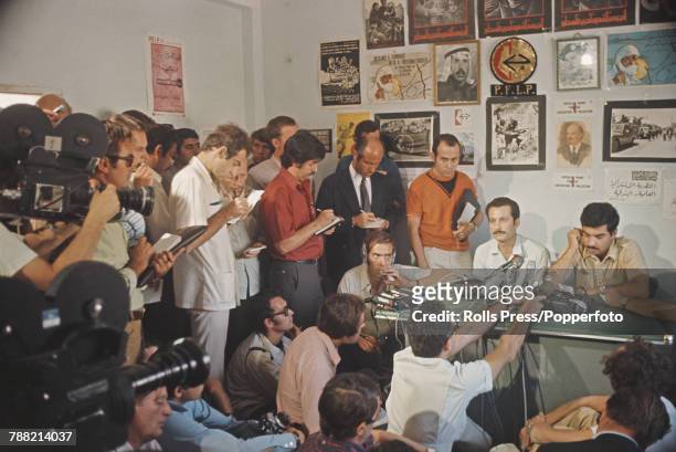 View of reporters and journalists crowding around Palestinian author Ghassan Kanafani at a Popular Front for the Liberation of Palestine press...