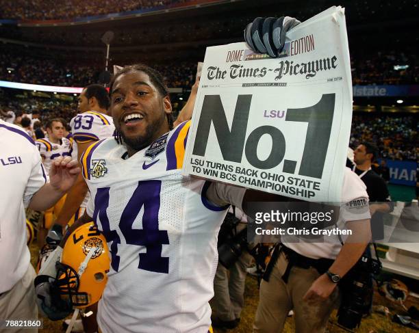 Danny McCray of the Louisiana State University Tigers raises the trophy after defeating the Ohio State Buckeyes 38-24 in the AllState BCS National...