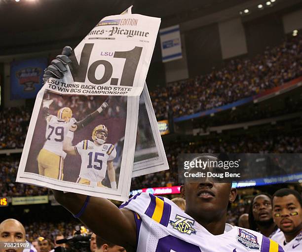 Terrance Toliver of the Louisiana State University Tigers holds up a newspaper in celebration after defeating the Ohio State Buckeyes 38-24 in the...
