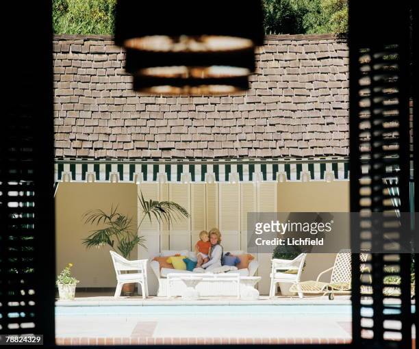 Jeanne Martin, ex wife of American singer and actor Dean Martin at home in California with a young child, October 1974. .