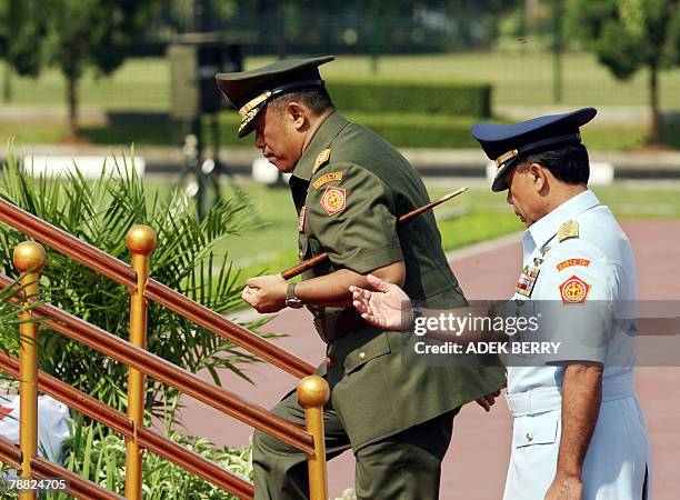 Outgoing Indonesian armed forces chief General Djoko Suyanto shows the way to incoming armed forces chief General Djoko Santoso during a ceremony in...