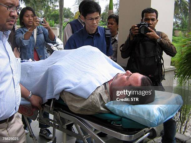 South African Terry G, one of the victim injured in a helicopter crash, is moved to a hospital in Pekan Baru, 08 January 2008. The helicopter was...