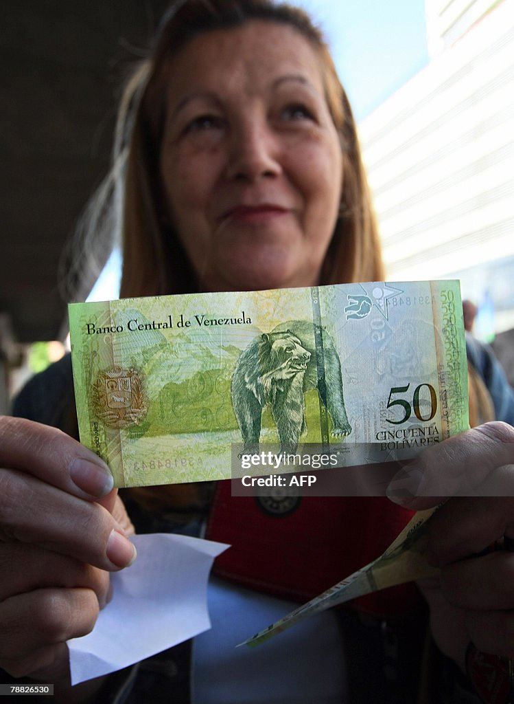 A woman shows a Venezuelan new 'bolivar