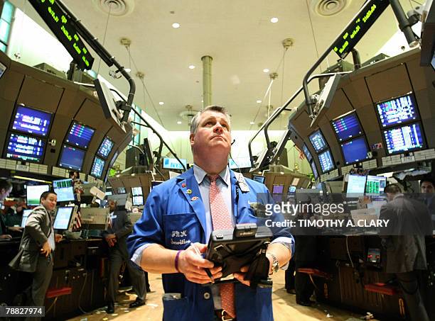 Trader James Kruse looks at the board as US Secretary of the Treasury Henry Paulson visits the New York Stock Exchange trading floor with NYSE...