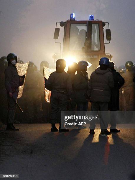 Policemen escort bulldozers to clean the streets in the Pozzuoli suburb west of Naples outside the Pianura dump, 08 January 2008. Italian troops will...