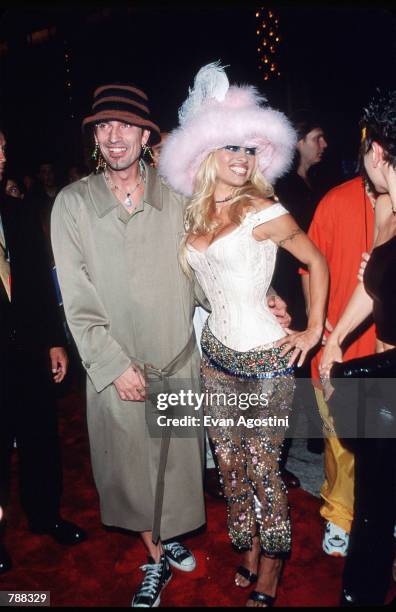 Pamela Anderson poses for a picture with husband Tommy Lee on September 9, 1999 at the MTV Video Music Awards in New York City. Anderson got her...