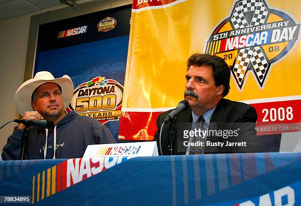 Country superstar Garth Brooks looks on as NASCAR President Mike Helton speaks to the media about NASCAR Day 2008 during NASCAR testing at Daytona...