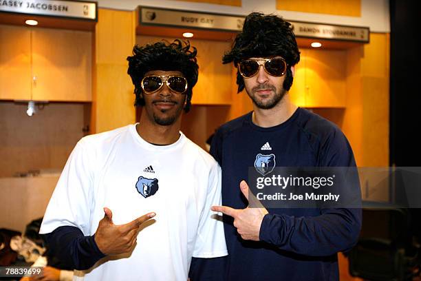 Michael Conley and Juan Carlos Navarro of the Memphis Grizzlies pose for a photograph wearing Elvis Presley wigs and sunglasses in honor of the...