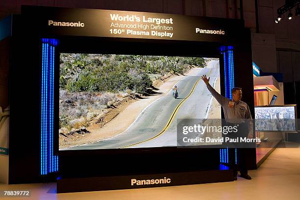 Man stands in front of the Panasonic 150 inch plasma display that was showcased at the 2008 International Consumer Electronics Show at the Las Vegas...