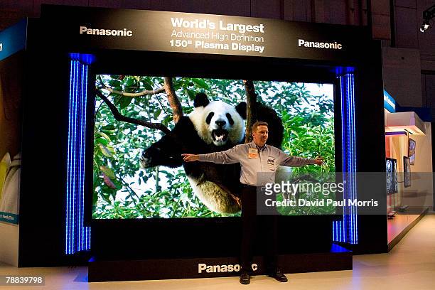 Man stands in front of the Panasonic 150 inch plasma display that was showcased at the 2008 International Consumer Electronics Show at the Las Vegas...