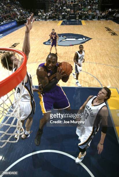 Kobe Bryant of the Los Angeles Lakers drives to the bakset between Pau Gasol and Mike Miller of the Memphis Grizzlies on January 8, 2008 at the...