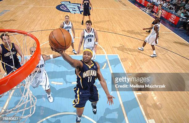 Jamaal Tinsley of the Indiana Pacers gets ahead of Carlos Boozer of the Utah Jazz for a fast-break score at EnergySolutions Arena on January 8, 2008...