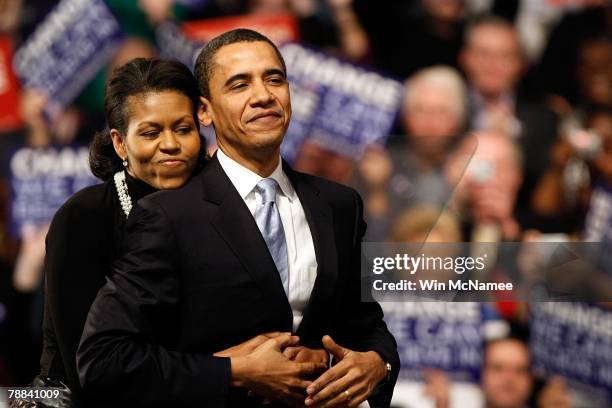 Democratic presidential hopeful Sen. Barack Obama is hugged by his wife Michelle Obama before his speech at a primary night rally in the gymnasium at...