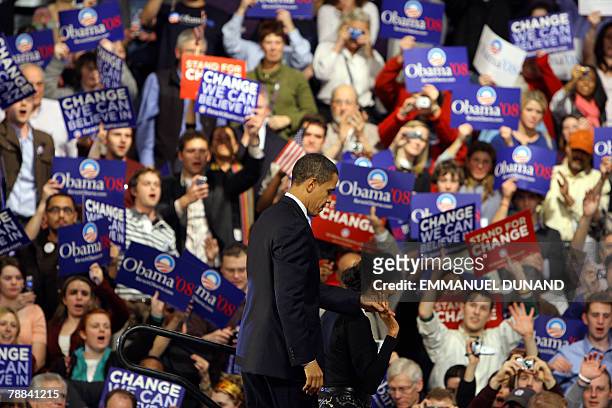Democratic presidential hopeful Barack Obama and his wife Michelle stand before supporters at a primary election results night rally in Nashua, 08...