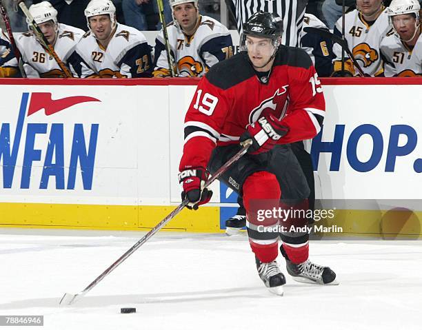 Travis Zajac of the New Jersey Devils plays the puck against the Buffalo Sabres during their game at the Prudential Center on January 8, 2008 in...