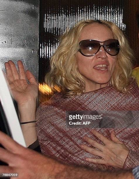 Multiple Grammy award winning pop star Madonna waves to waiting media outside a curio shop in Mumbai, 09 January 2008. Pop star Madonna, on the...