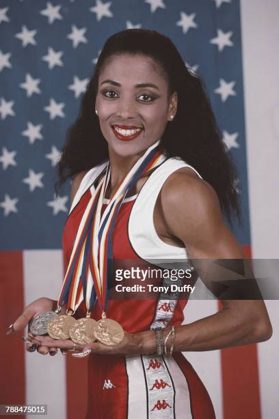 Florence Griffith-Joyner poses for a portrait in front of the Stars and Stripes flag of theUnited States with her medals for winning gold in the...