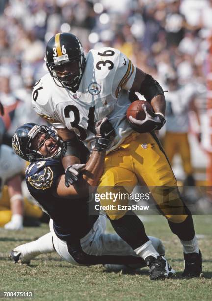 Jerome Bettis, Running Back for the Pittsburgh Steelers is tackled Michael McCrary defensive end for the Baltimore Ravens during the American...