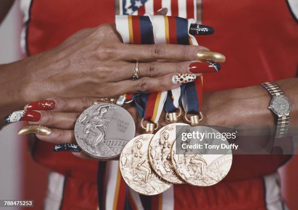 Close-up as American athlete Florence Griffith Joyner displays her medals from the Summer Olympic Games in Seoul, South Korea, September 25, 1988....